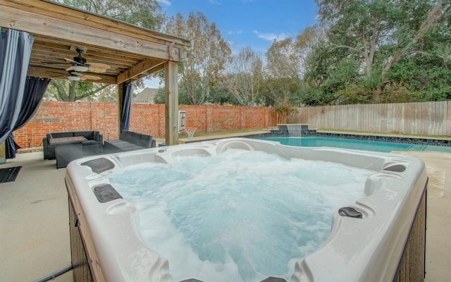 view of swimming pool featuring a fenced backyard, ceiling fan, and a hot tub