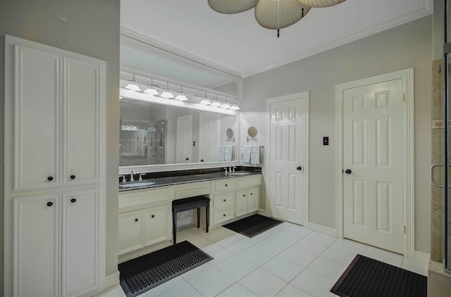 full bathroom featuring ornamental molding, a stall shower, and a sink