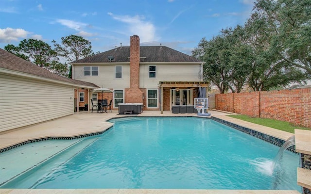 view of pool with a hot tub, a fenced in pool, a patio, a fenced backyard, and french doors