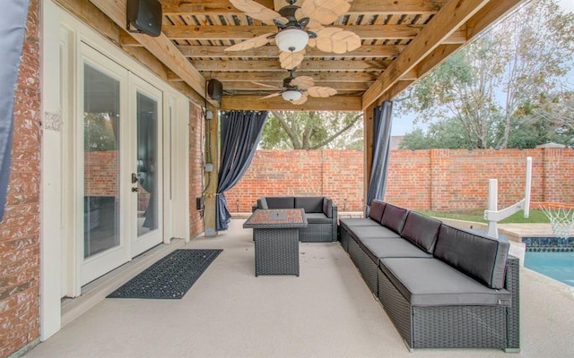 view of patio / terrace featuring french doors, a fenced backyard, an outdoor living space, and a ceiling fan