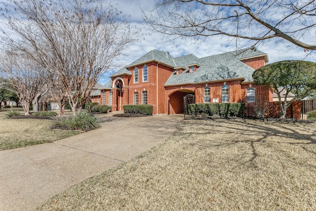 view of front of property with brick siding and a front yard