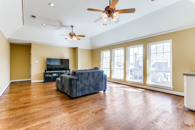 living area with light wood-type flooring, visible vents, and baseboards