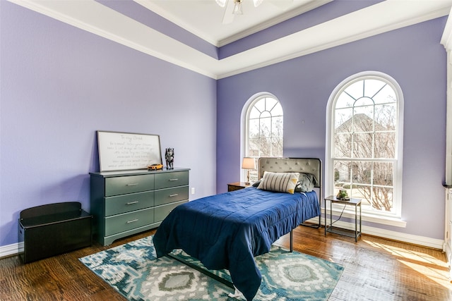 bedroom featuring crown molding, baseboards, and dark wood-style flooring