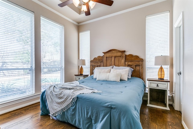 bedroom featuring ceiling fan, dark wood-type flooring, and crown molding