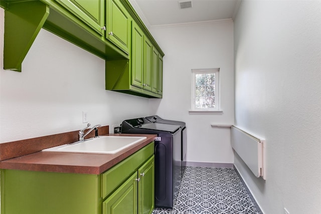 washroom featuring separate washer and dryer, a sink, visible vents, baseboards, and ornamental molding