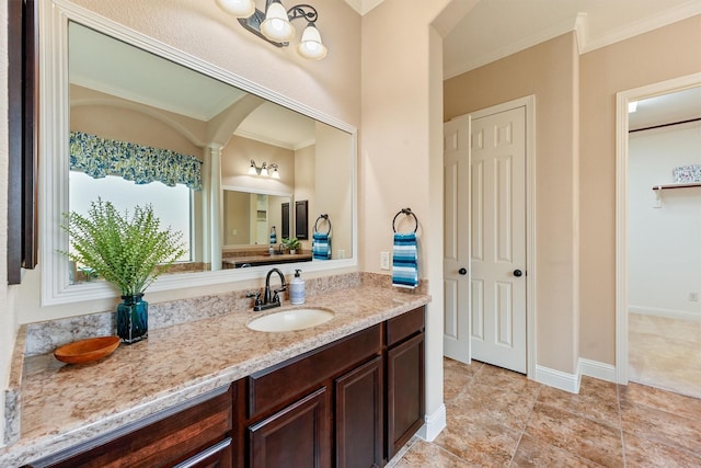 bathroom featuring baseboards, vanity, and crown molding