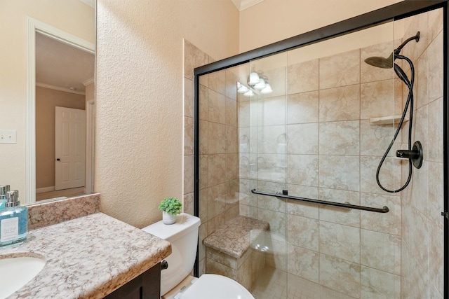 full bathroom with a textured wall, toilet, vanity, a stall shower, and crown molding