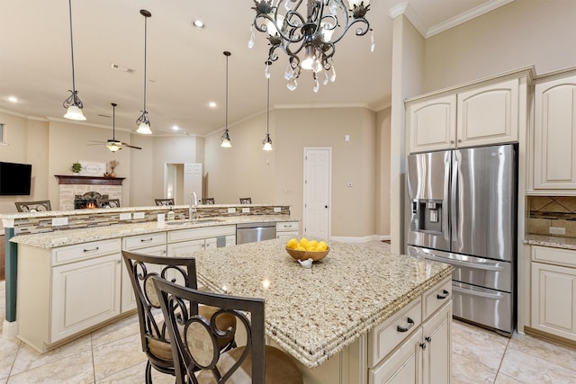 kitchen with stainless steel appliances, a kitchen island, a sink, and crown molding