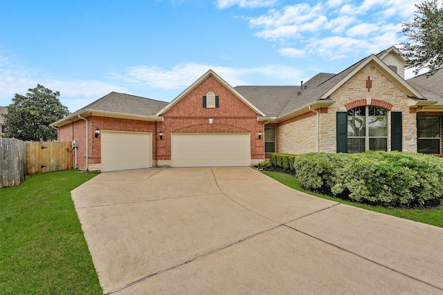 view of front of property featuring brick siding, an attached garage, fence, stone siding, and driveway