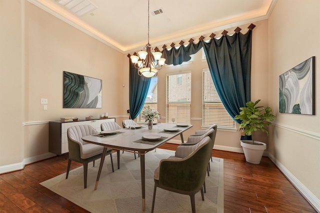 dining area with dark wood-style flooring, visible vents, baseboards, an inviting chandelier, and crown molding