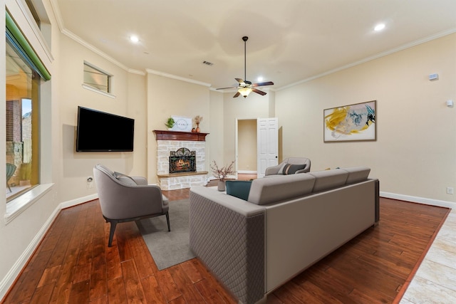 living area with a fireplace, baseboards, dark wood finished floors, and crown molding