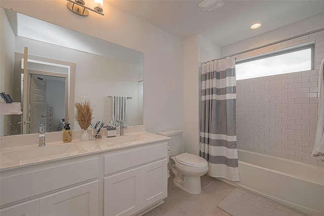 full bathroom featuring double vanity, visible vents, shower / bath combo with shower curtain, and a sink