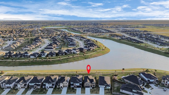 drone / aerial view with a water view and a residential view