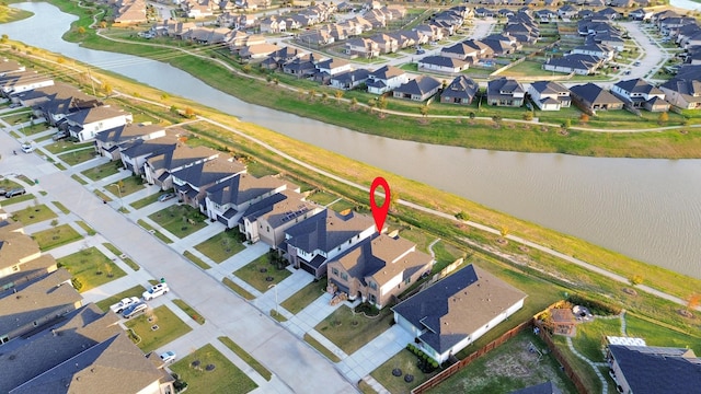 birds eye view of property with a water view and a residential view