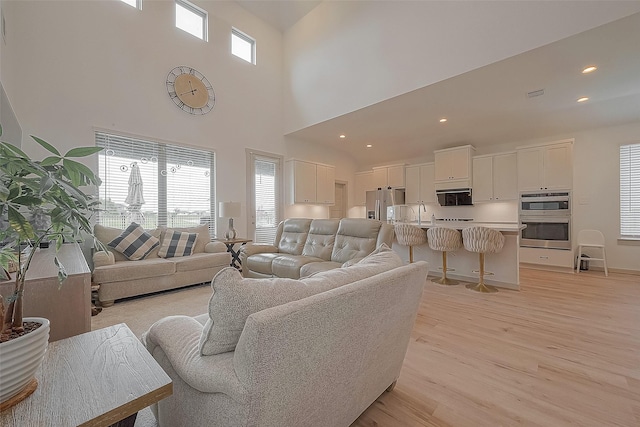 living room with visible vents, a wealth of natural light, light wood-style flooring, and recessed lighting