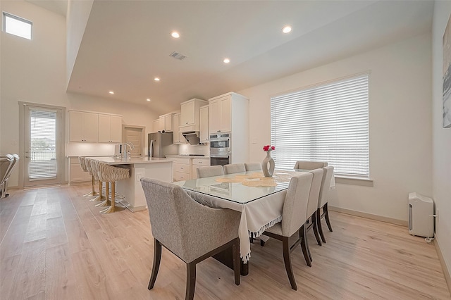 dining room featuring light wood-type flooring, baseboards, and recessed lighting