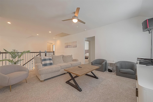 living area with lofted ceiling, light carpet, visible vents, and recessed lighting