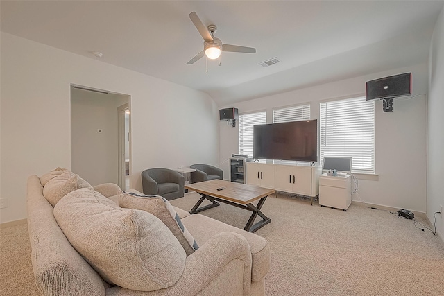 living room with light carpet, visible vents, baseboards, and a ceiling fan