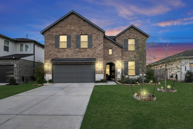 traditional home featuring driveway, a garage, a front lawn, and brick siding