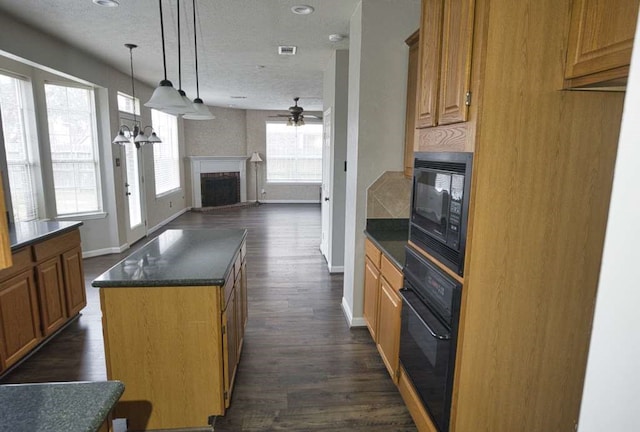 57 Sunrose Ct, Lake Jackson, TX 77566 - kitchen featuring dark countertops, open floor plan, black appliances, a fireplace, and pendant lighting