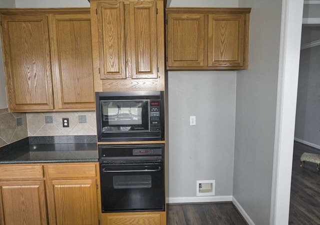 57 Sunrose Ct, Lake Jackson, TX 77566 - kitchen featuring black appliances, dark wood-type flooring, backsplash, and brown cabinets