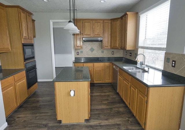 57 Sunrose Ct, Lake Jackson, TX 77566 - kitchen featuring a kitchen island, under cabinet range hood, black appliances, pendant lighting, and a sink