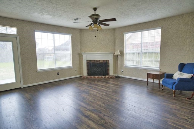 57 Sunrose Ct, Lake Jackson, TX 77566 - unfurnished living room with dark wood-style floors, a fireplace, baseboards, and a textured ceiling