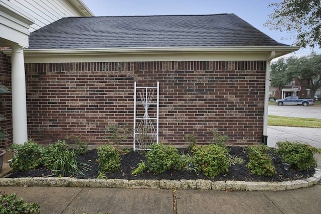 57 Sunrose Ct, Lake Jackson, TX 77566 - view of home's exterior with a shingled roof and brick siding