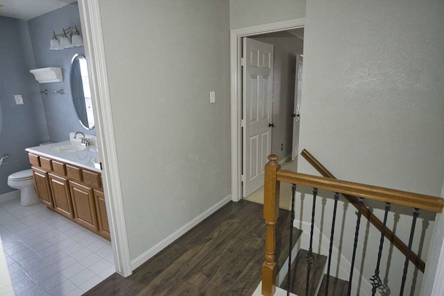 57 Sunrose Ct, Lake Jackson, TX 77566 - interior space featuring toilet, baseboards, wood finished floors, and vanity