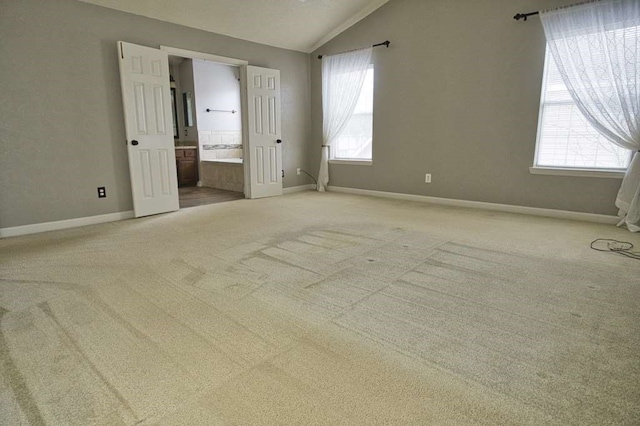 57 Sunrose Ct, Lake Jackson, TX 77566 - unfurnished bedroom with lofted ceiling, multiple windows, and light carpet