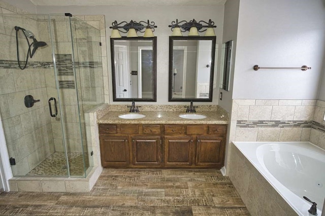 57 Sunrose Ct, Lake Jackson, TX 77566 - full bathroom featuring a garden tub, a sink, a shower stall, and double vanity