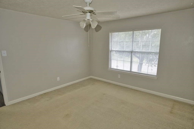 57 Sunrose Ct, Lake Jackson, TX 77566 - empty room with light carpet, a ceiling fan, baseboards, and a textured ceiling
