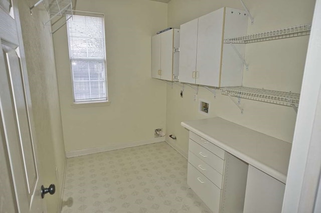 57 Sunrose Ct, Lake Jackson, TX 77566 - laundry area featuring light floors, hookup for a washing machine, cabinet space, electric dryer hookup, and baseboards