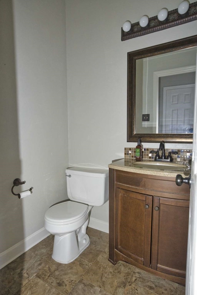 57 Sunrose Ct, Lake Jackson, TX 77566 - bathroom featuring toilet, baseboards, and vanity