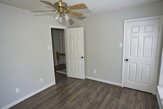 57 Sunrose Ct, Lake Jackson, TX 77566 - spare room featuring dark wood-style floors, a textured ceiling, and baseboards