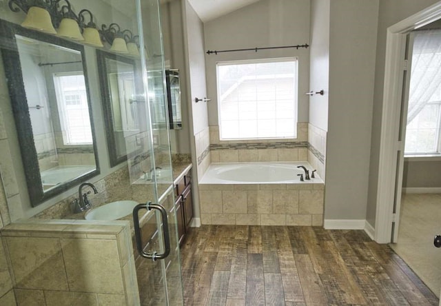 57 Sunrose Ct, Lake Jackson, TX 77566 - bathroom with lofted ceiling, wood finished floors, a sink, and a bath