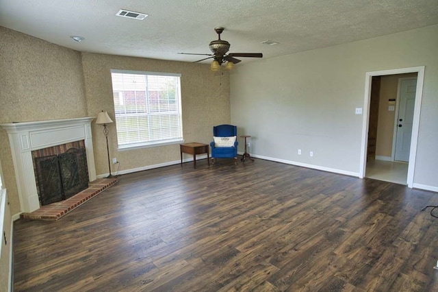 57 Sunrose Ct, Lake Jackson, TX 77566 - unfurnished room with dark wood-type flooring, a brick fireplace, visible vents, and baseboards