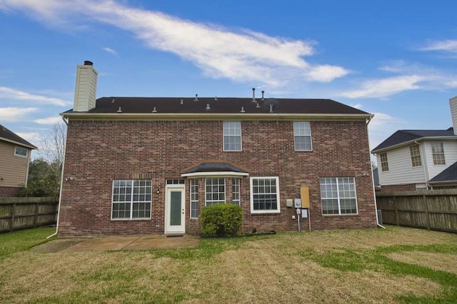 57 Sunrose Ct, Lake Jackson, TX 77566 - rear view of property featuring brick siding, a patio, a chimney, a lawn, and a fenced backyard
