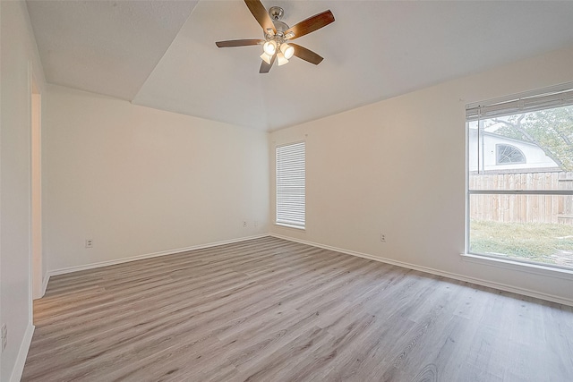 empty room with plenty of natural light, baseboards, and light wood-style flooring