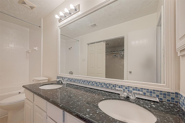 bathroom with visible vents, a sink, a textured ceiling, and toilet