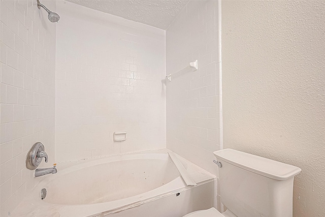 full bathroom featuring a textured ceiling, a textured wall, shower / bath combination, and toilet