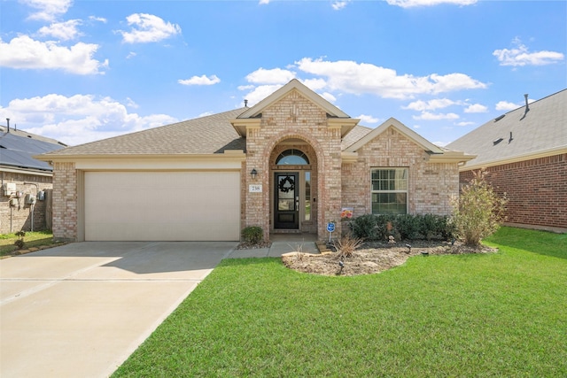 view of front of home with a front lawn, concrete driveway, and brick siding