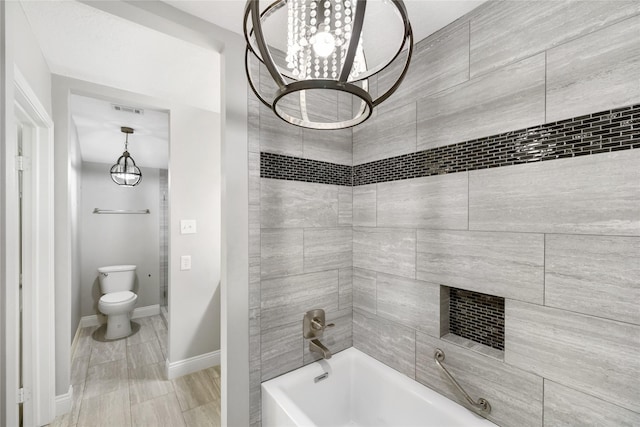 bathroom featuring baseboards, visible vents, shower / bathing tub combination, and toilet