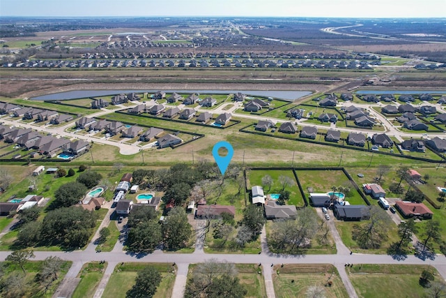 birds eye view of property with a water view and a residential view