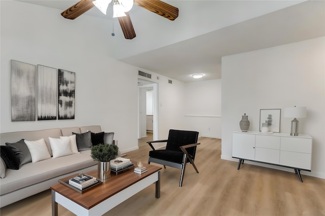 living area with ceiling fan, light wood-type flooring, and baseboards