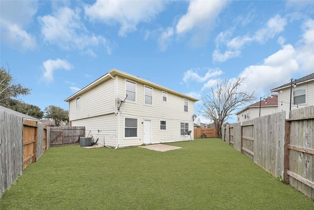 rear view of property with central AC, a yard, and a fenced backyard