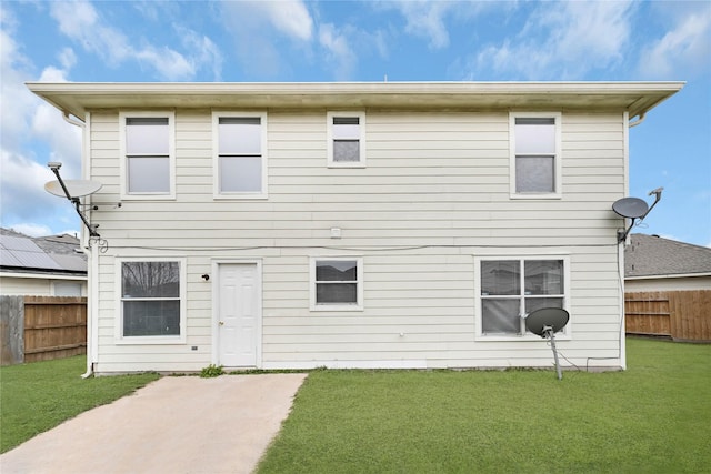 back of property with a patio area, fence, and a lawn