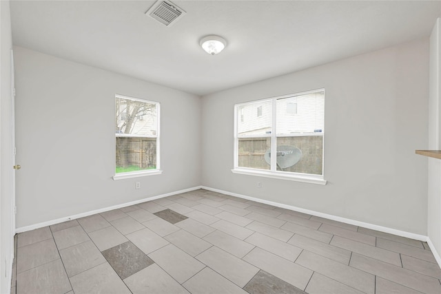 empty room with visible vents and baseboards