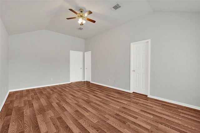 spare room with baseboards, visible vents, a ceiling fan, lofted ceiling, and wood finished floors