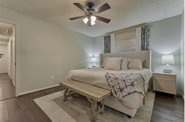 bedroom with dark wood-style floors, a textured ceiling, a ceiling fan, and baseboards